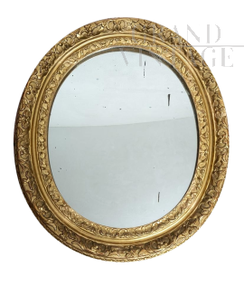 Antique French Louis XVI oval mirror in gilded and carved wood
