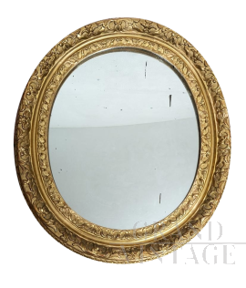 Antique French Louis XVI oval mirror in gilded and carved wood