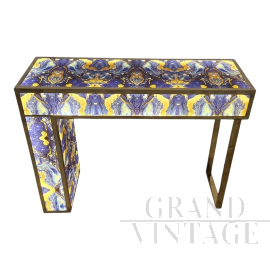 Asymmetric design console in backlit blue and gold glass