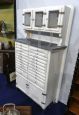 Vintage high cupboard in white wood with small drawers and marble top