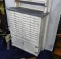 Vintage high cupboard in white wood with small drawers and marble top