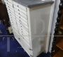 Vintage high cupboard in white wood with small drawers and marble top