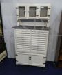 Vintage high cupboard in white wood with small drawers and marble top