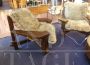 Pair of design armchairs in wood and rope with faux fur cushions