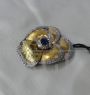 1960s brooch in gold in the shape of a violet with diamonds and sapphire