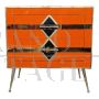 Art deco style bedside cabinet in orange glass with geometries