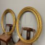 Pair of antique carved and gilded oval frames