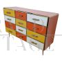 Dresser with 12 drawers in yellow and orange colored glass