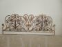 Antique wrought iron bed headboard painted with gold highlights, 19th century