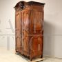 Antique Louis XV wardrobe or cupboard in walnut and cherry with carvings, 18th century