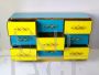 Design chest of drawers with 9 drawers in yellow and blue glass