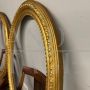 Pair of antique carved and gilded oval frames