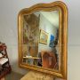 Large antique gilded mirror with a wavy shape