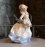 Vintage porcelain sculpture, little girl with a basket of flowers