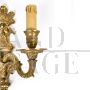 Pair of baroque style wall lights in golden brass