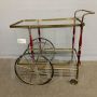 Cesare Lacca serving trolley in brass, glass and burgundy lacquered wood