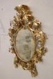 Antique baroque oval cartouche mirror in carved and gilded wood, 18th century