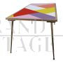 Design table in brass and color block glass