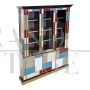 Large bookcase covered in colored glass and illuminated