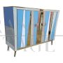 Two-door sideboard with light blue glass and brass geometries