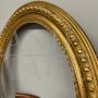 Pair of antique carved and gilded oval frames