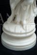 Antique sculpture of a girl with a cherub in statuary white marble