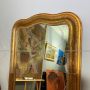 Large antique gilded mirror with a wavy shape