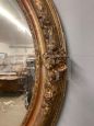 Antique oval mirror from 1840 in gold leaf