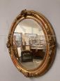 Antique oval mirror from 1840 in gold leaf      