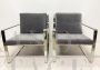 Minimalist design armchairs in metal and dark gray fabric