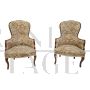 Pair of vintage wooden armchairs covered with floral fabric