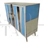 Two-door sideboard with light blue glass and brass geometries