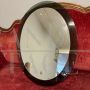 Vintage 1970s oval mirror with green glass frame