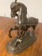 Antique antimony sculpture of a horse with a character, late 19th century