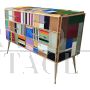 Design dresser with six drawers covered in multicolored glass