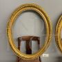 Pair of antique carved and gilded oval frames