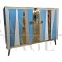 Two-door sideboard with light blue glass and brass geometries