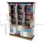 Large bookcase covered in colored glass and illuminated 