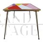 Design table in brass and color block glass