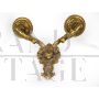 Pair of baroque style wall lights in golden brass