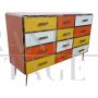 Dresser with 12 drawers in yellow and orange colored glass