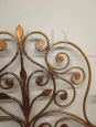 Antique wrought iron bed headboard painted with gold highlights, 19th century