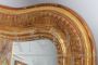 Large antique gilded mirror with a wavy shape