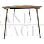 Design table in brass and color block glass