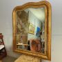 Large antique gilded mirror with a wavy shape