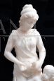 Antique sculpture of a girl with a cherub in statuary white marble