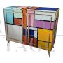 Sideboard in colored glass with illuminated mirror interior