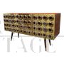 Three-door brass sideboard with circular red glass inserts