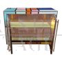 Sideboard in colored glass with illuminated mirror interior