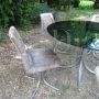 Vintage lounge set with glass and steel table and 4 pony skin chairs, 1970s